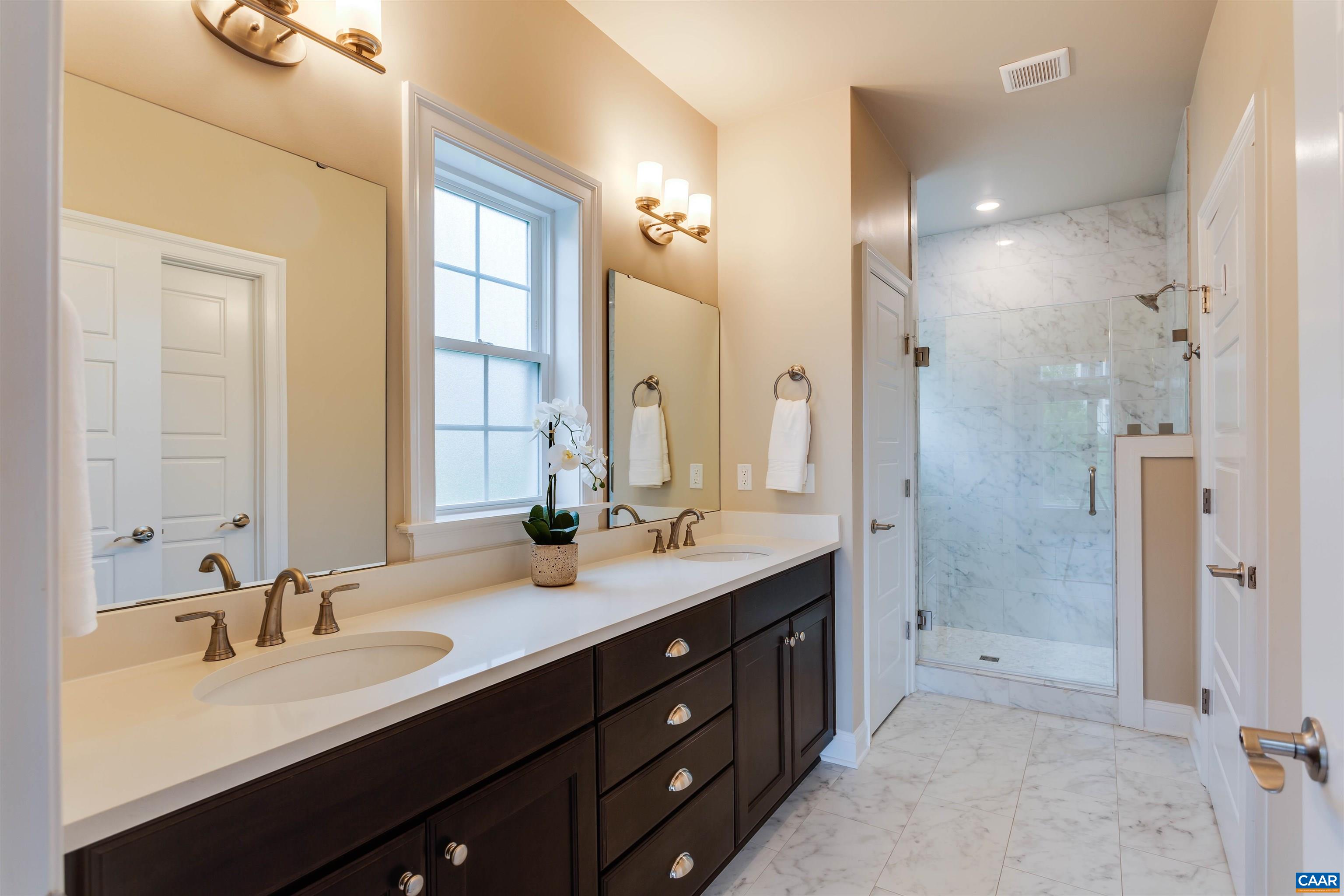 596 Drumin Road Keswick, VA 22947 - Photo 25 of 57 a bathroom with a double vanity sink mirror double and shower