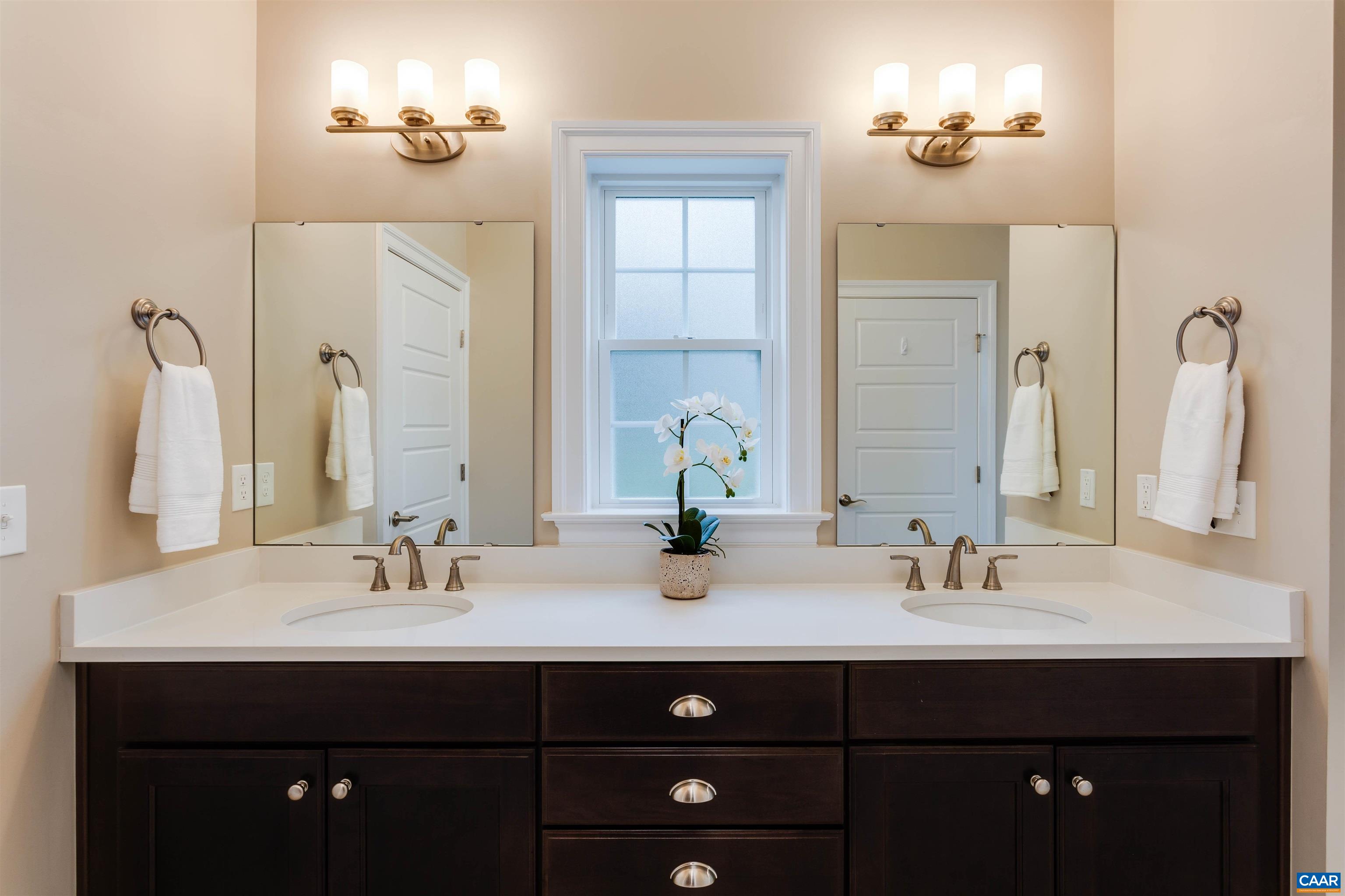 596 Drumin Road Keswick, VA 22947 - Photo 27 of 57 a bathroom with double sink and two mirror
