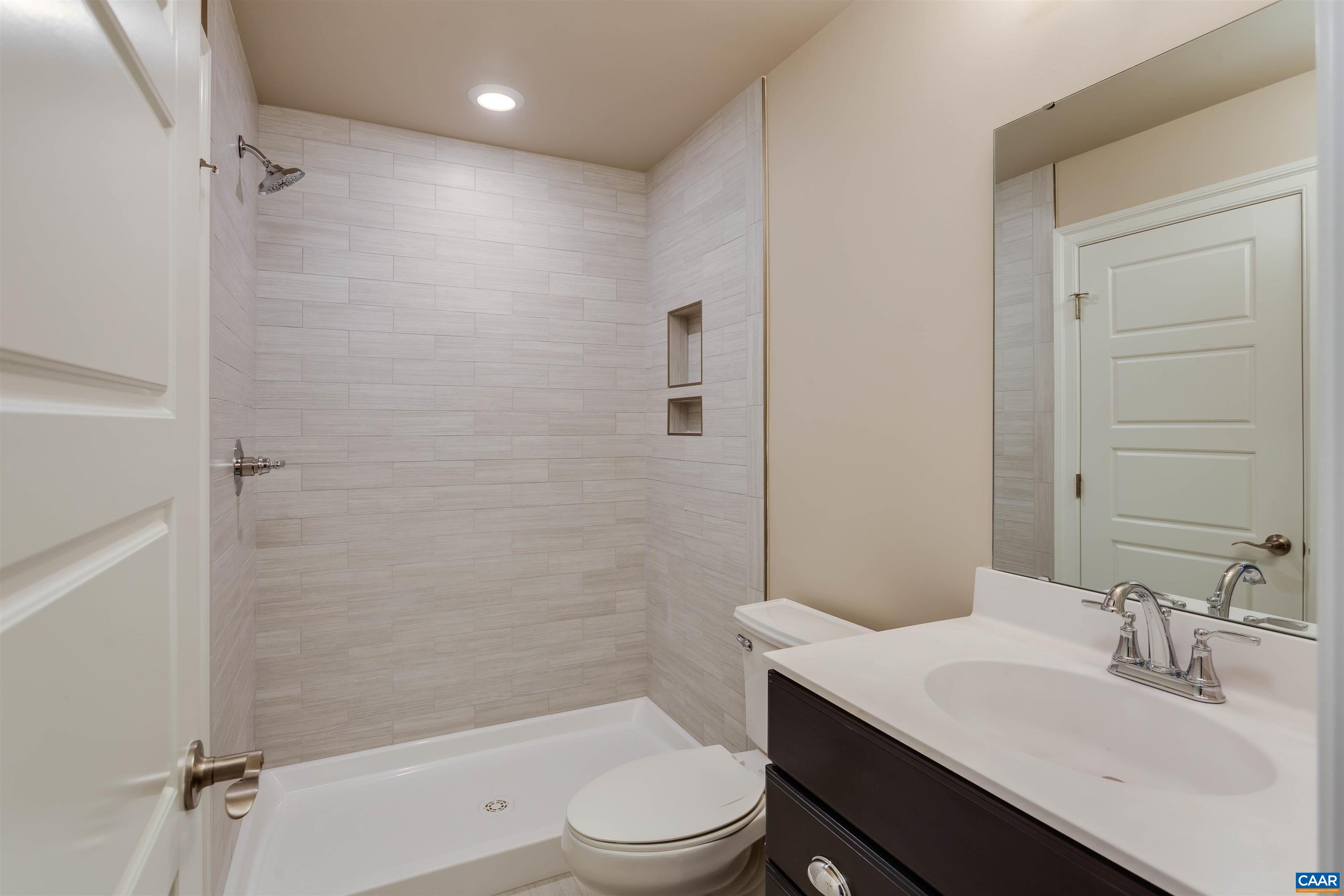 596 Drumin Road Keswick, VA 22947 - Photo 48 of 57 a bathroom with a sink a toilet and shower