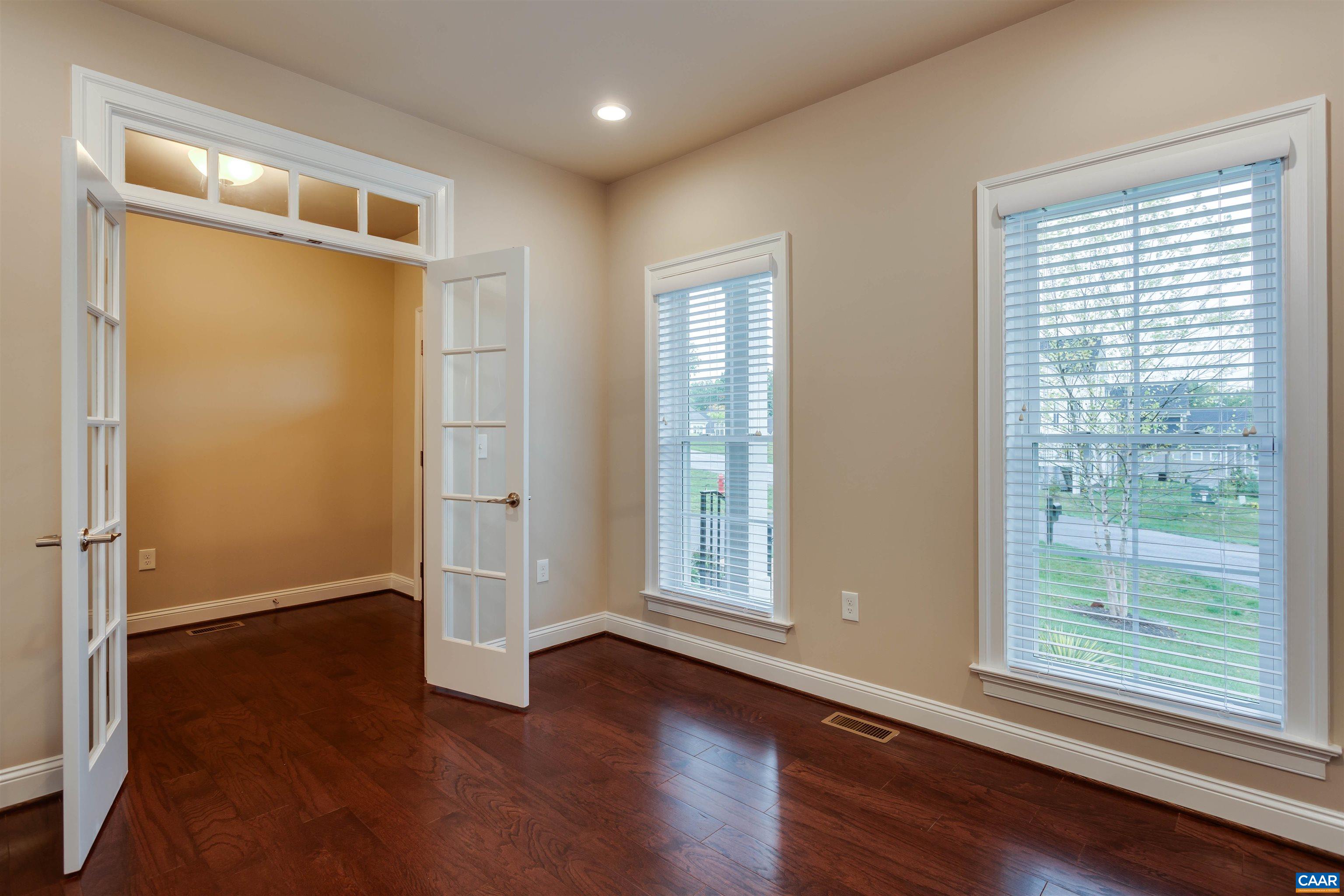 596 Drumin Road Keswick, VA 22947 - Photo 7 of 57 an empty room with wooden floor and windows