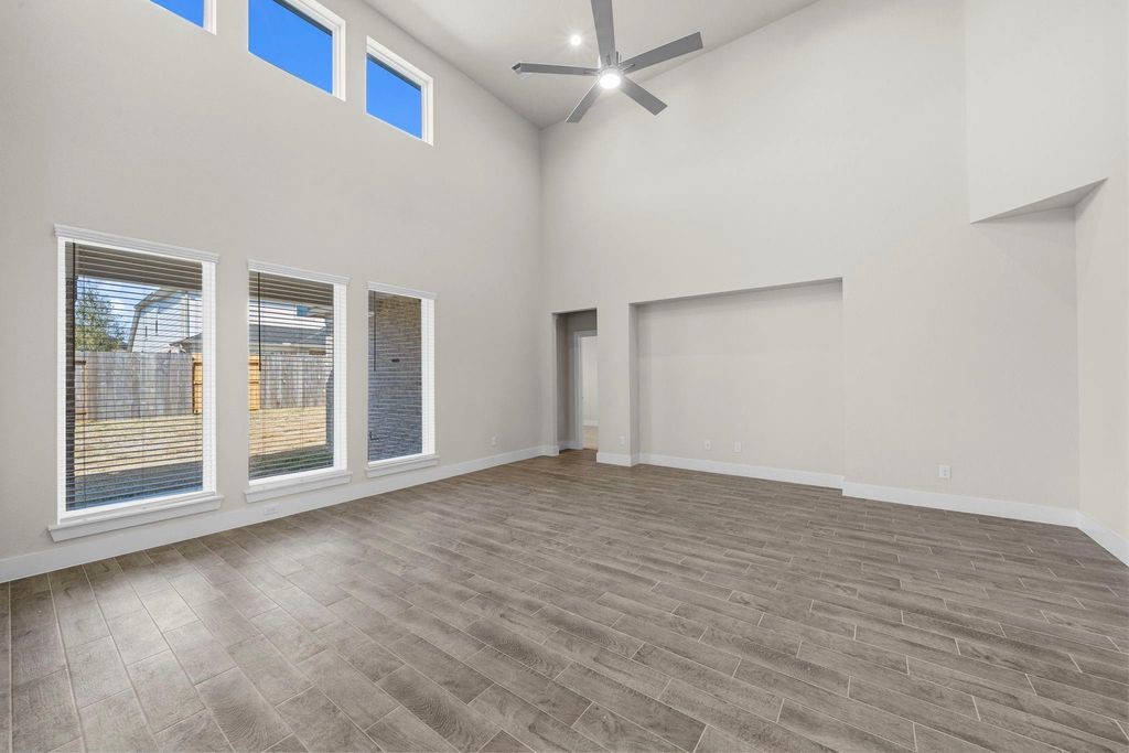 1972 Golden Spruce Lane Conroe, TX 77301 - Photo 8 of 19 a view of an empty room with wooden floor and a window