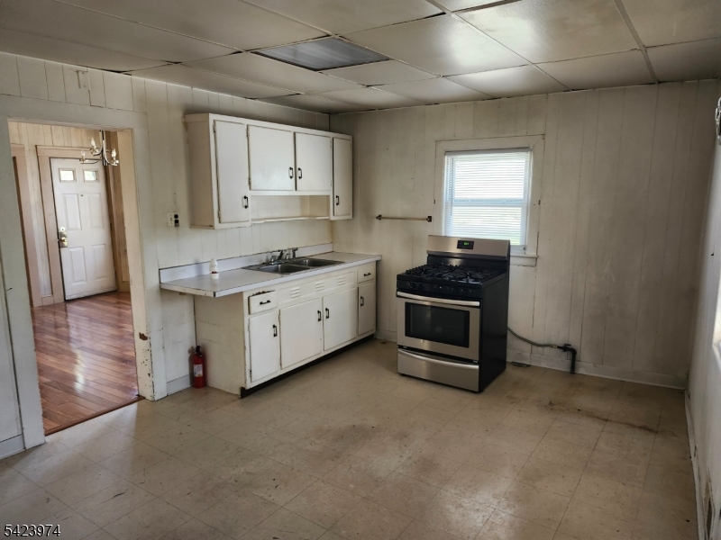5 Locust Street Wanaque, NJ 07420 - Photo 10 of 23 a kitchen with stainless steel appliances granite countertop a stove a sink and a refrigerator
