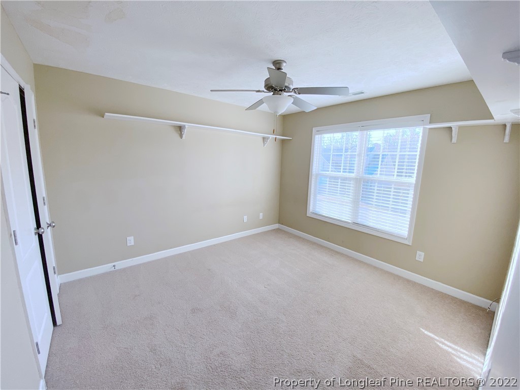 587 Cape Fear Road Raeford, NC 28376 - Photo 12 of 16 en empty room with windows and ceiling fan