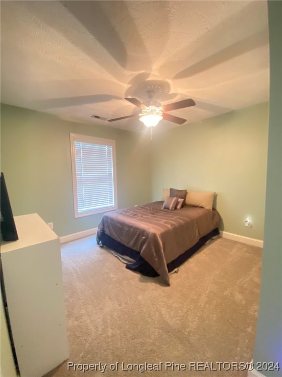 2729 H Bullard Road Hope Mills, NC 28348 - Photo 8 of 15 a bedroom with a bed and a chandelier