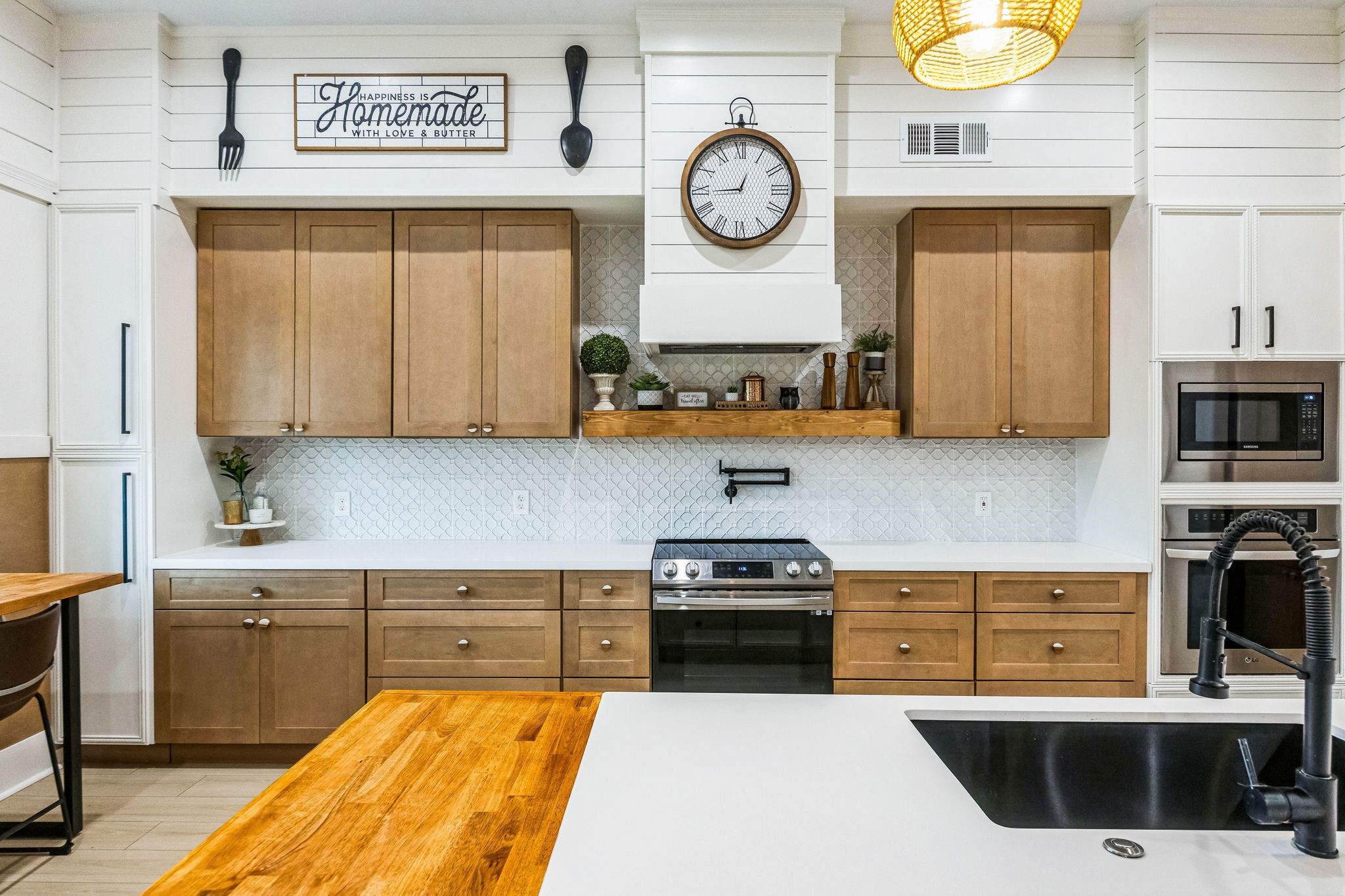 209 Horse Shoe Trail Angleton, TX 77515 - Photo 12 of 43 a kitchen with stainless steel appliances a stove a sink and a clock on the cabinets