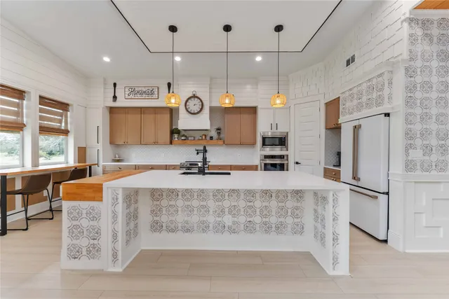 a kitchen with stainless steel appliances a sink stove and cabinets