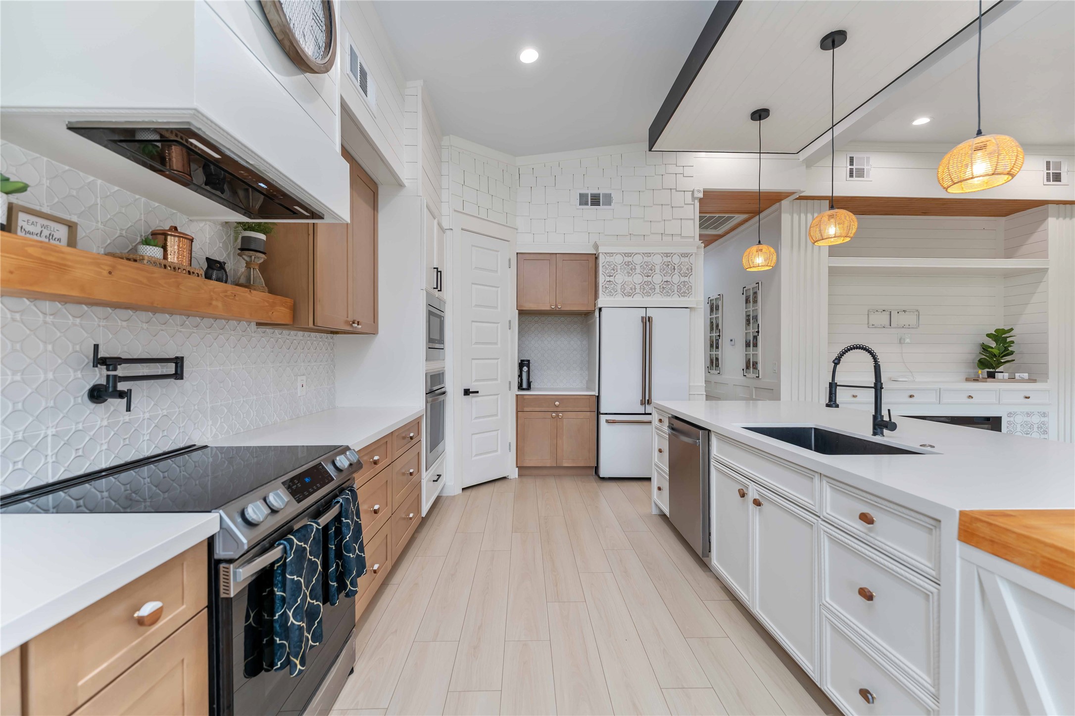 209 Horse Shoe Trail Angleton, TX 77515 - Photo 13 of 43 a kitchen with stainless steel appliances a sink stove and cabinets