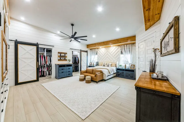 a spacious bathroom with a granite countertop sink and a large mirror