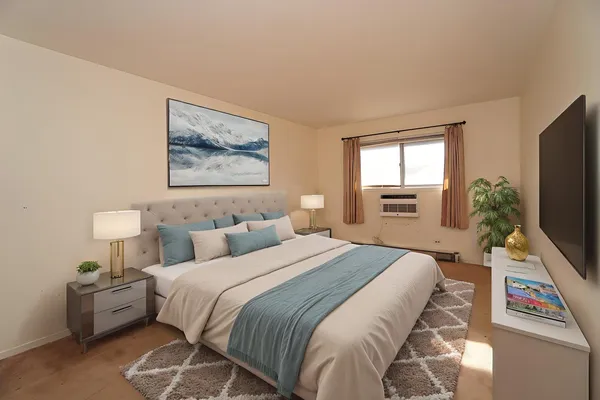 a bedroom with a bed and a flat screen tv