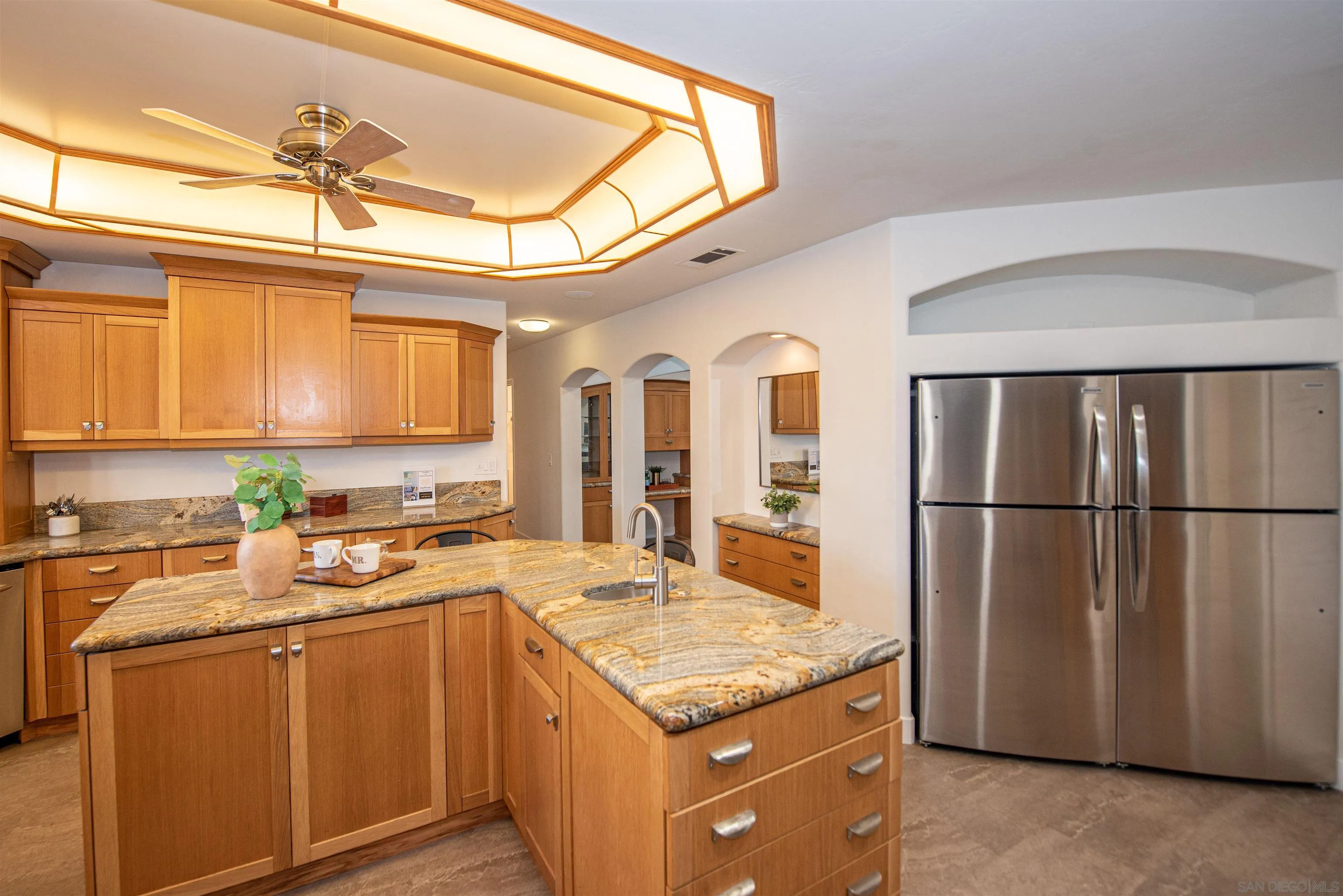 13419 Sebago Avenue Poway, CA 92064 - Photo 14 of 44 a kitchen with stainless steel appliances granite countertop a refrigerator a sink dishwasher a stove and white cabinets with wooden floor