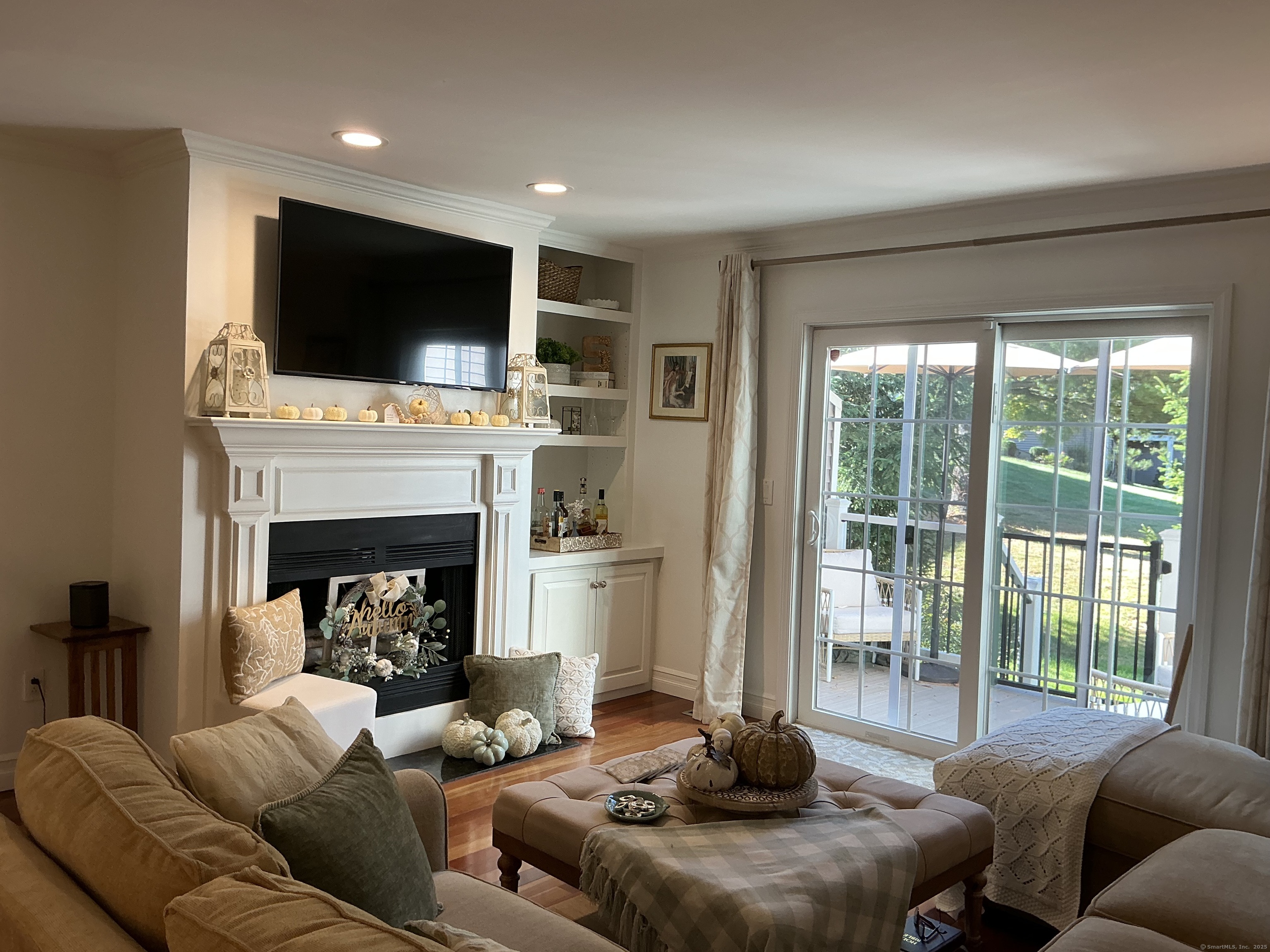 751 Long Hill Road, Unit C Middletown, CT 06457 - Photo 11 of 30 a living room with furniture a flat screen tv and a fireplace