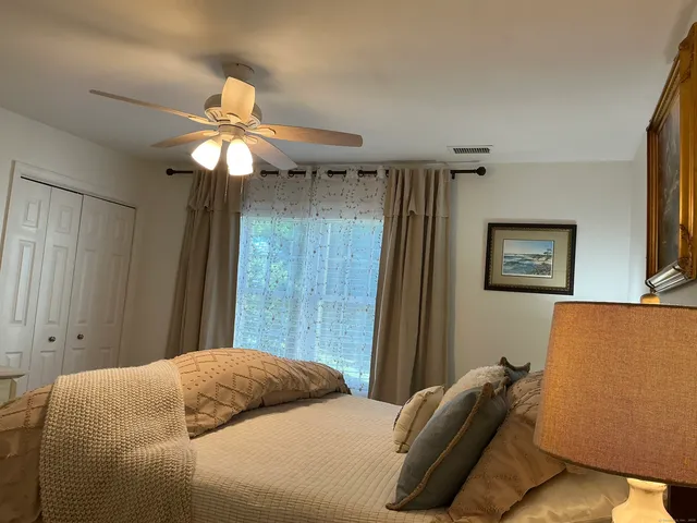a view of a hallway to a livingroom with furniture