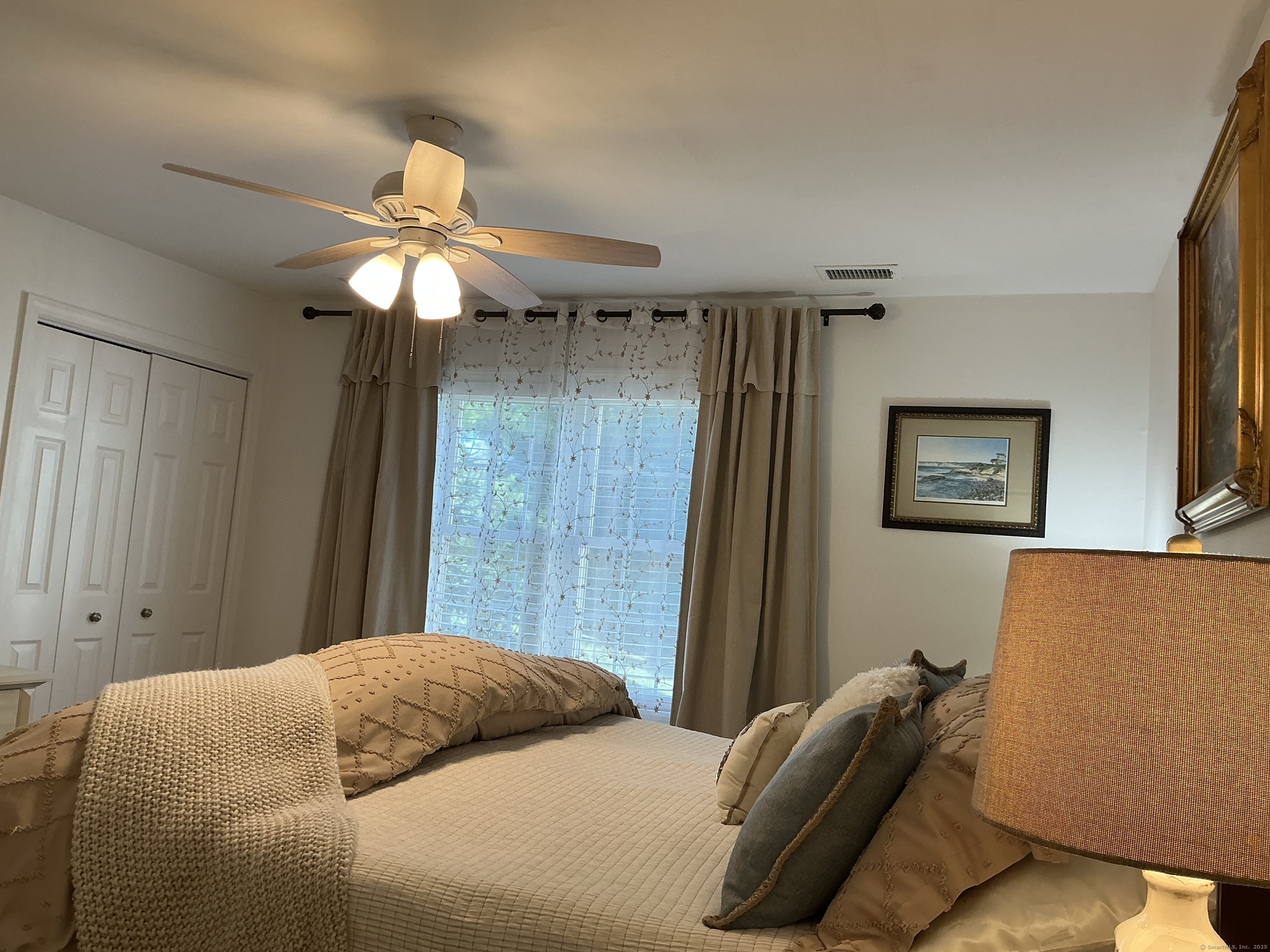 751 Long Hill Road, Unit C Middletown, CT 06457 - Photo 17 of 30 a bedroom with a bed and a chandelier