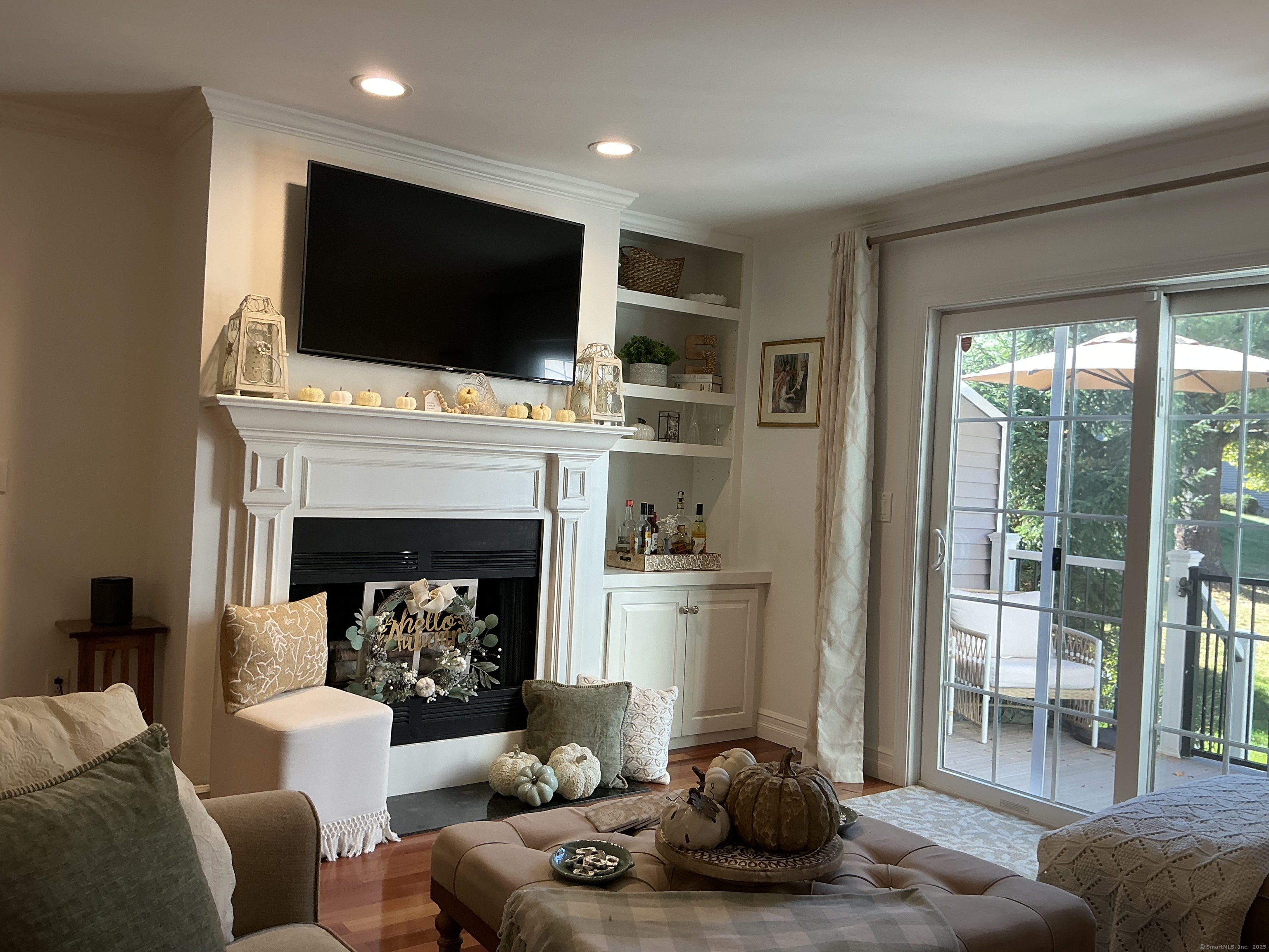751 Long Hill Road, Unit C Middletown, CT 06457 - Photo 26 of 30 a living room with furniture a flat screen tv and a fireplace
