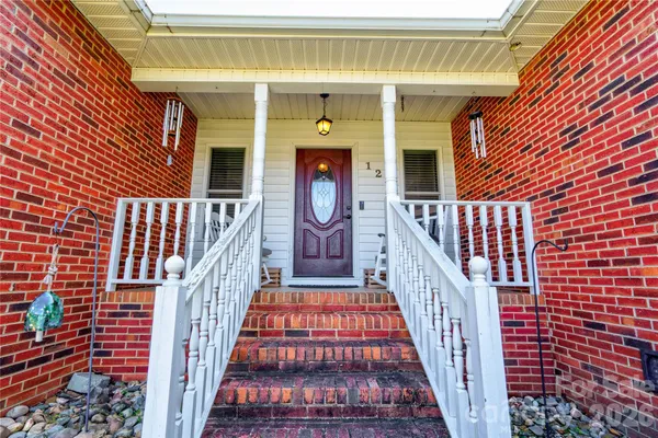 a view of a hallway with furniture and wooden floor