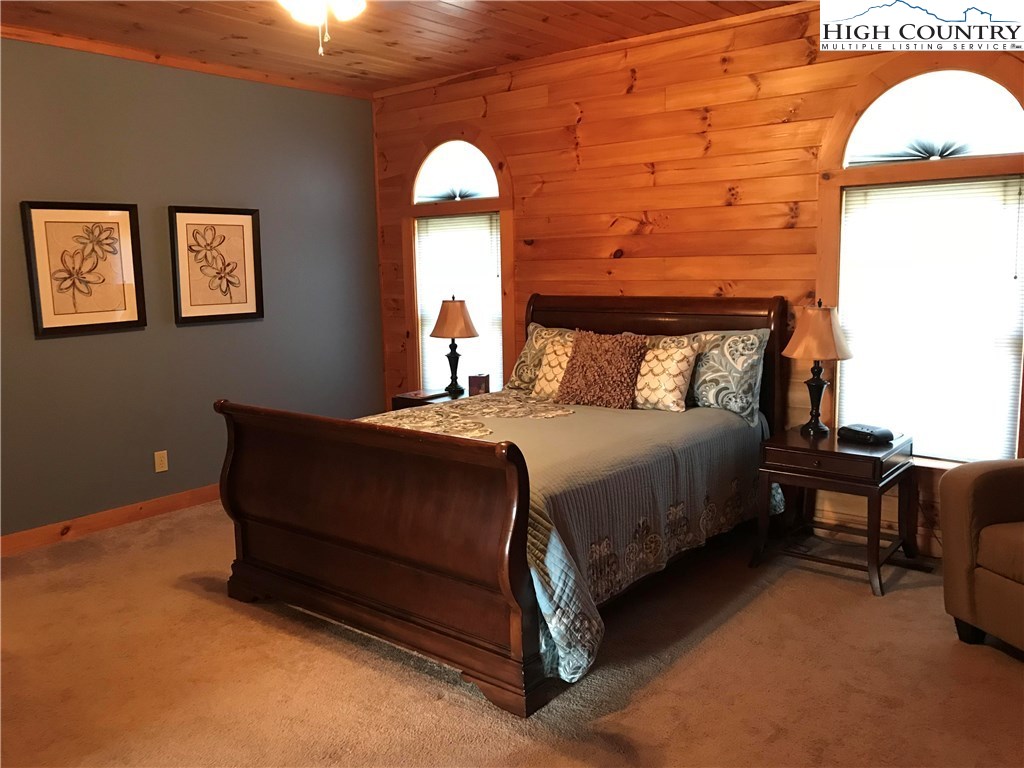 146 Quick Boone, NC 28607 - Photo 11 of 22 a bed sitting in a bedroom next to a lamp