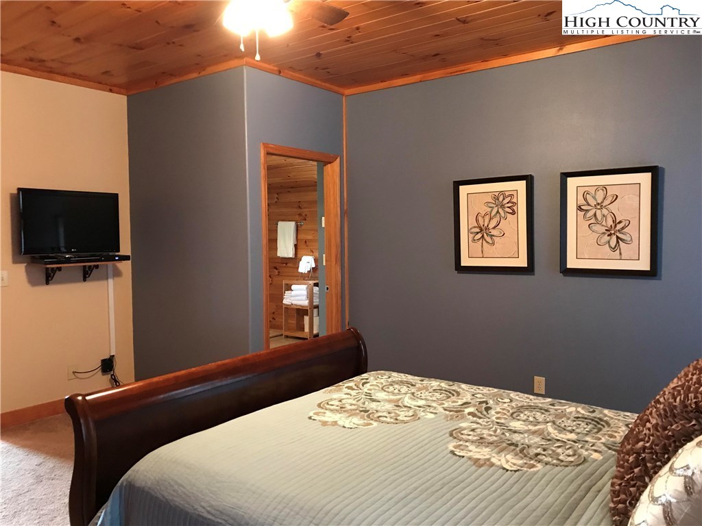 146 Quick Boone, NC 28607 - Photo 10 of 22 a bedroom with a bed and a flat screen tv