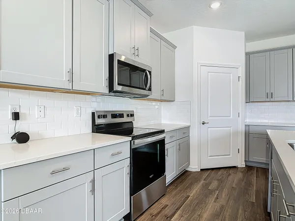 a kitchen with cabinets and stainless steel appliances