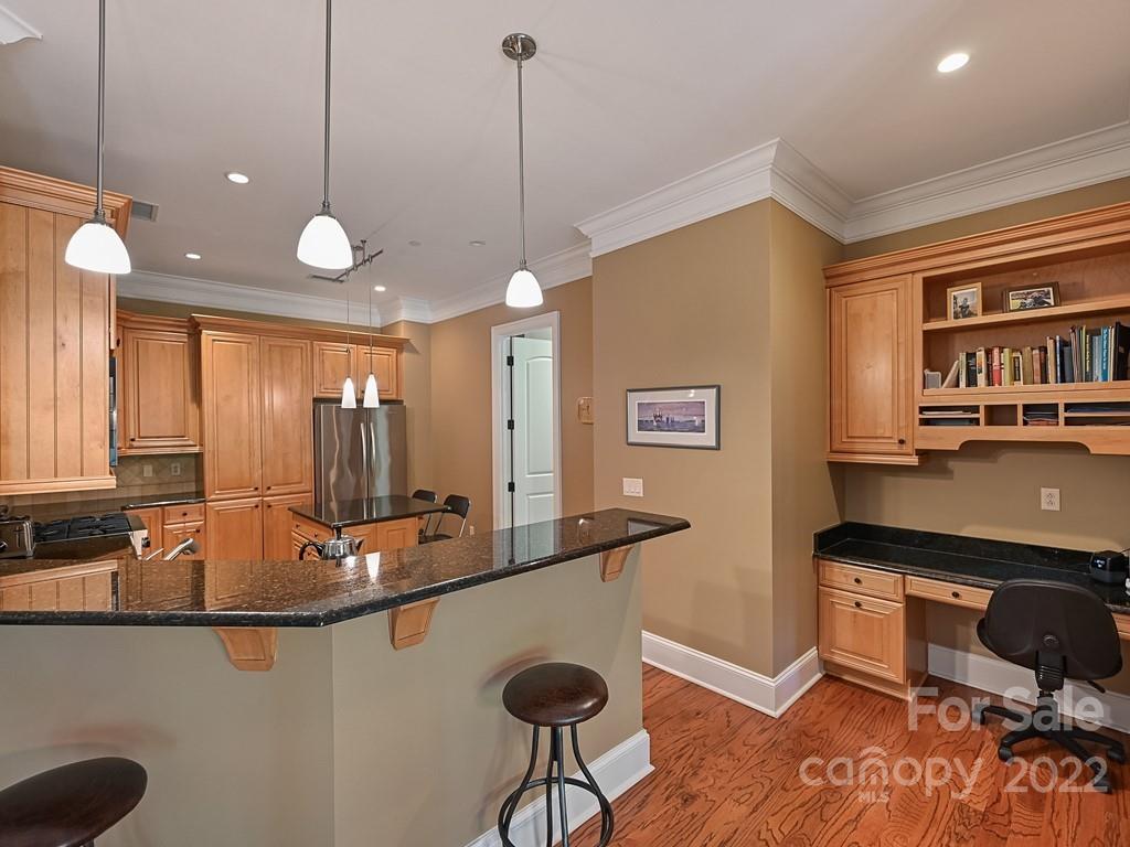 2823 Providence Road, Unit 133 Charlotte, NC 28211 - Photo 13 of 43 a kitchen with stainless steel appliances granite countertop a sink a stove and a wooden floor