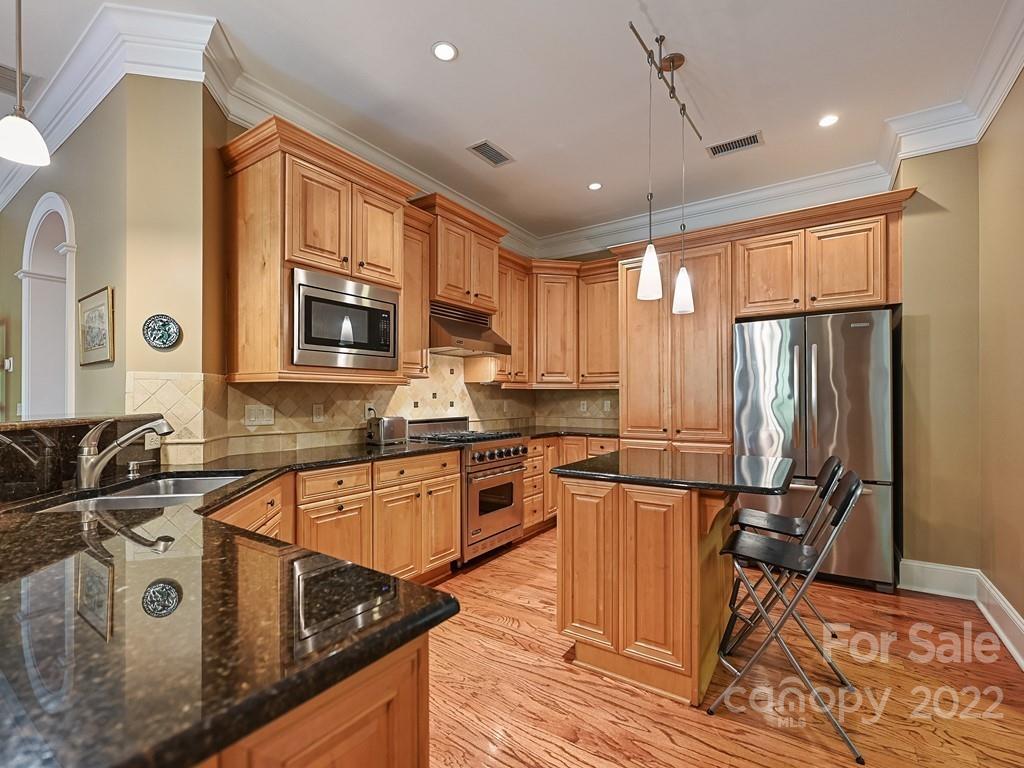 2823 Providence Road, Unit 133 Charlotte, NC 28211 - Photo 15 of 43 a kitchen with granite countertop a refrigerator stove and sink