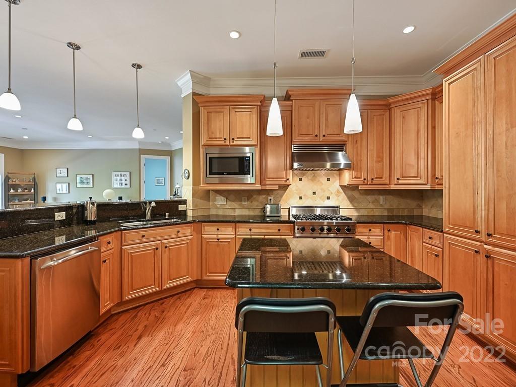 2823 Providence Road, Unit 133 Charlotte, NC 28211 - Photo 16 of 43 a kitchen with sink a stove and chairs