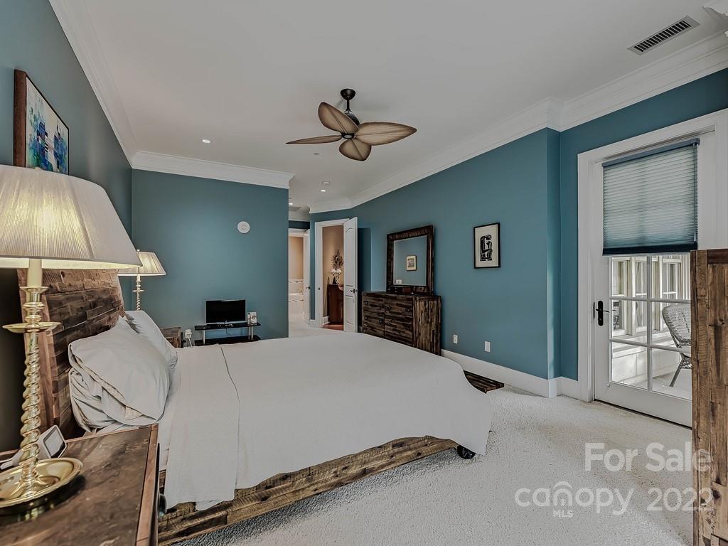 2823 Providence Road, Unit 133 Charlotte, NC 28211 - Photo 20 of 43 a bedroom with a bed and a chandelier