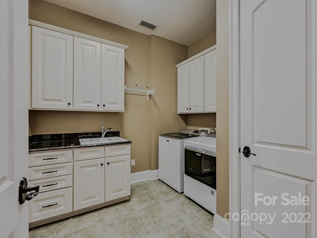 2823 Providence Road, Unit 133 Charlotte, NC 28211 - Photo 26 of 43 a kitchen with granite countertop white cabinets and stainless steel appliances