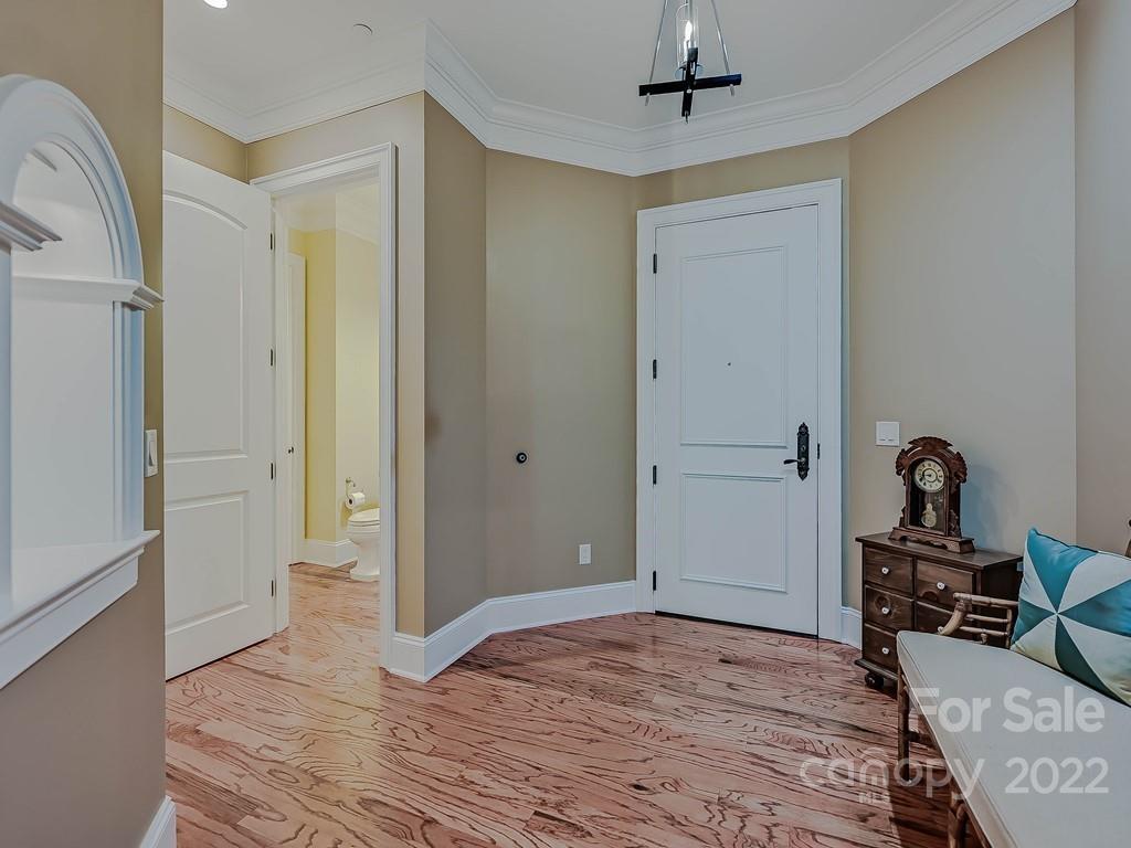 2823 Providence Road, Unit 133 Charlotte, NC 28211 - Photo 4 of 43 a bedroom with a bed and a chandelier