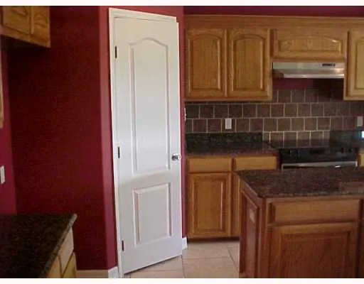 a kitchen with a refrigerator and cabinets