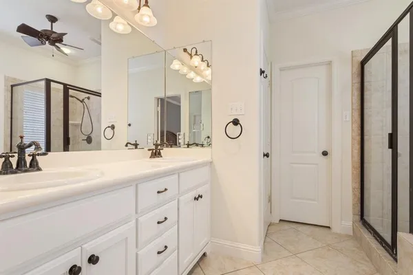 a bathroom with a double vanity sink mirror and