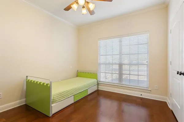 a bedroom with a bed and a large window