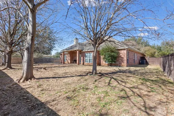 a view of a yard with a house and a tree