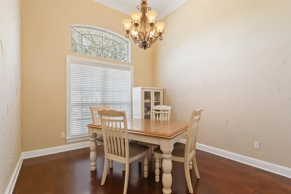 a view of a dining room with furniture and a chandelier