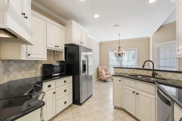 a kitchen with stainless steel appliances a refrigerator sink and cabinets
