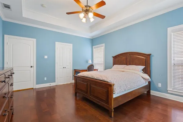 a bedroom with a bed and a chandelier