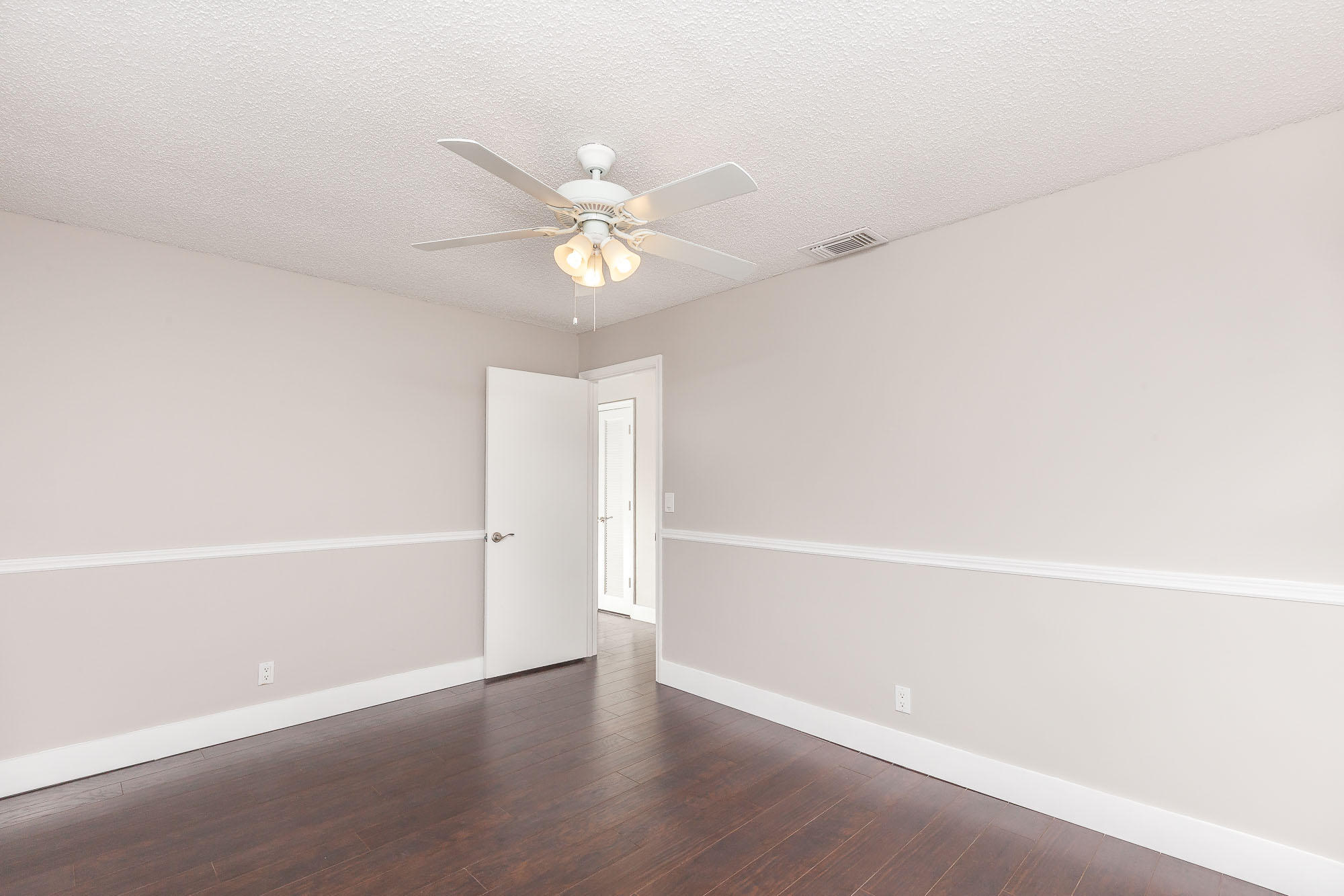 9868 Liberty Road Boca Raton, FL 33434 - Photo 18 of 22 a view of an empty room with a ceiling fan and a window