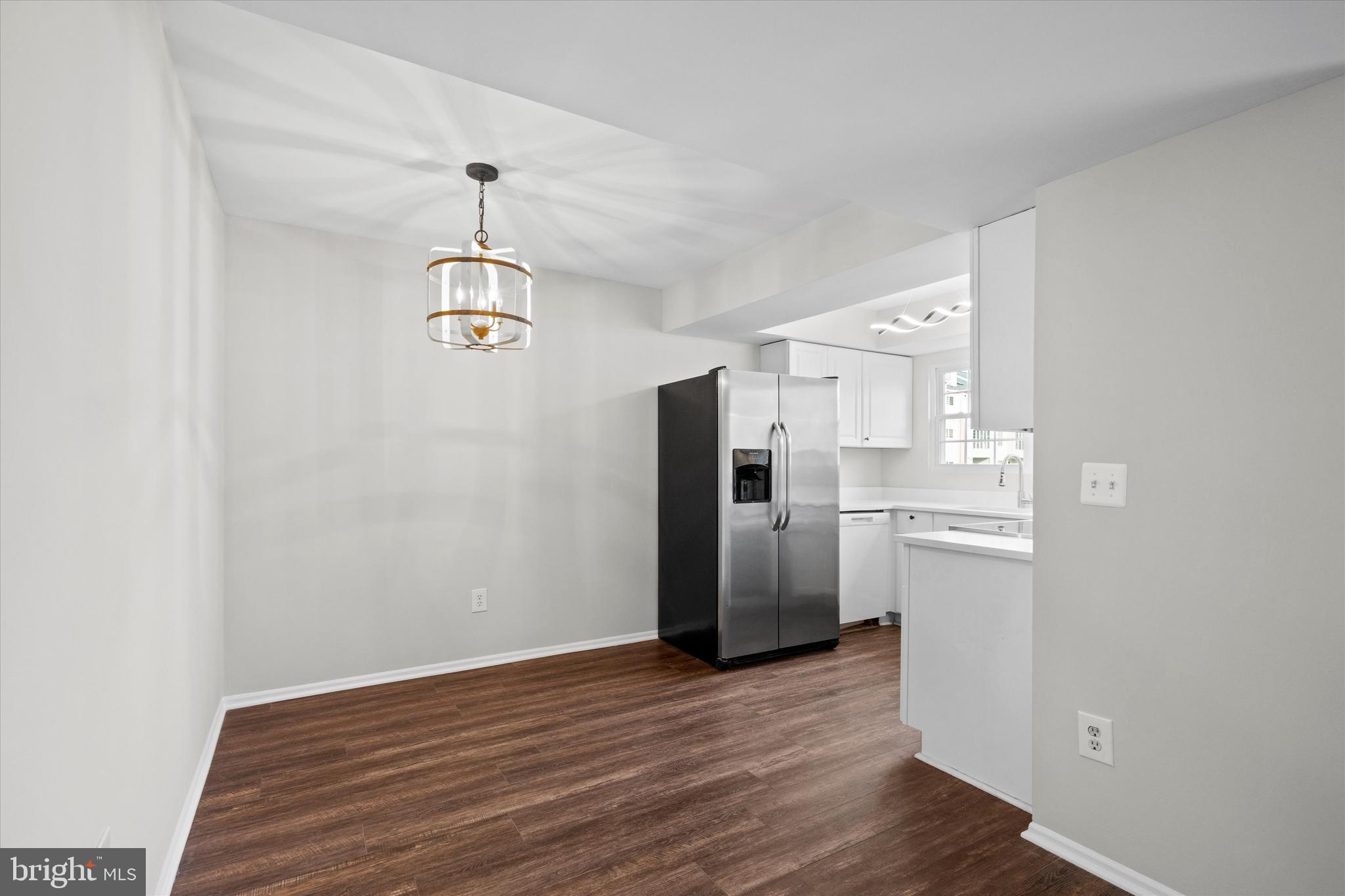 129 Fort Evans Road Southeast, Unit A Leesburg, VA 20175 - Photo 11 of 33 a kitchen with stainless steel appliances a refrigerator and a chandelier