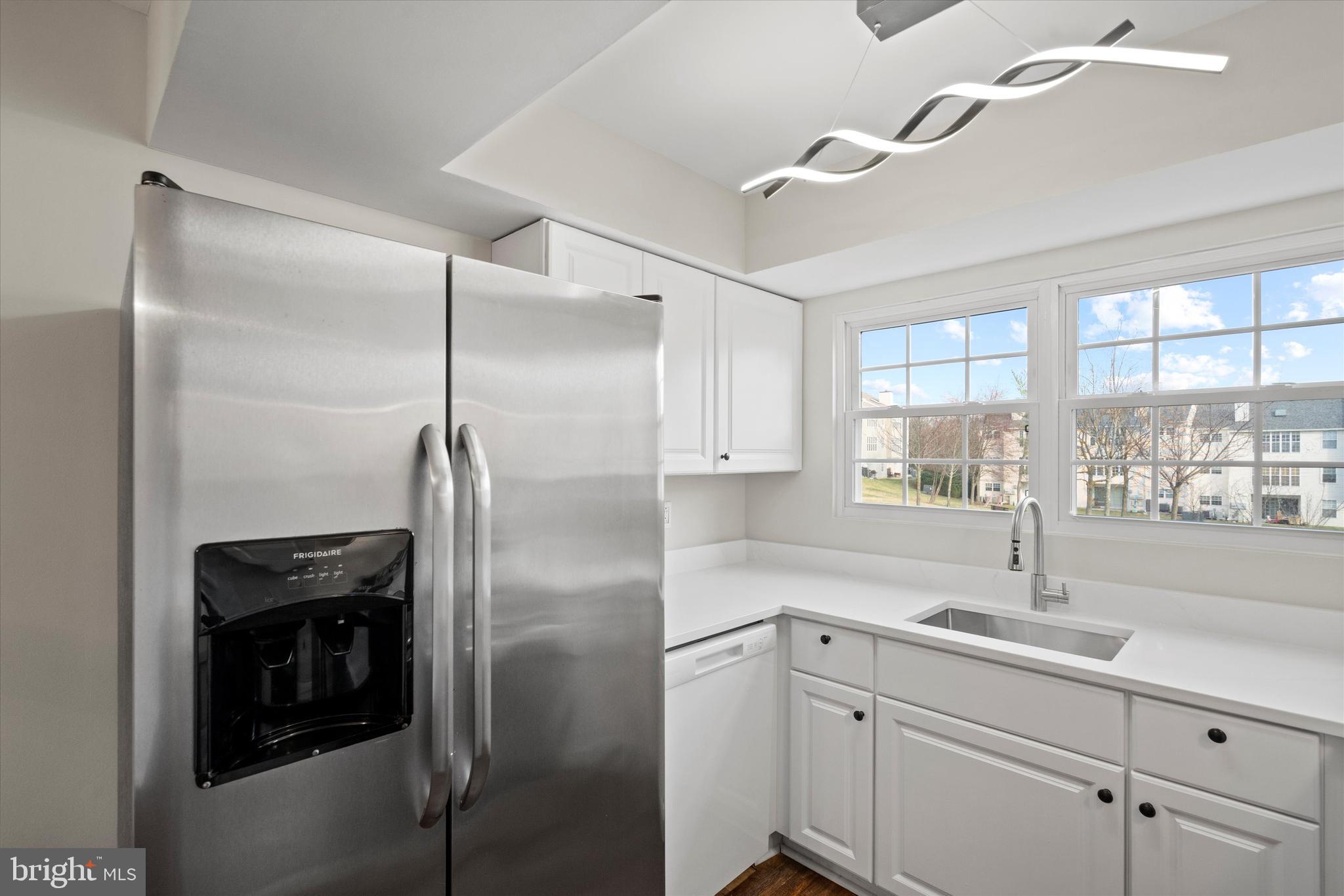 129 Fort Evans Road Southeast, Unit A Leesburg, VA 20175 - Photo 15 of 33 a kitchen with a sink and refrigerator