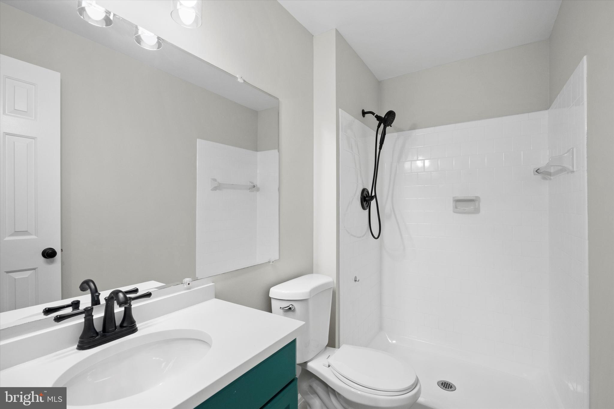 129 Fort Evans Road Southeast, Unit A Leesburg, VA 20175 - Photo 16 of 33 a bathroom with a sink toilet and shower