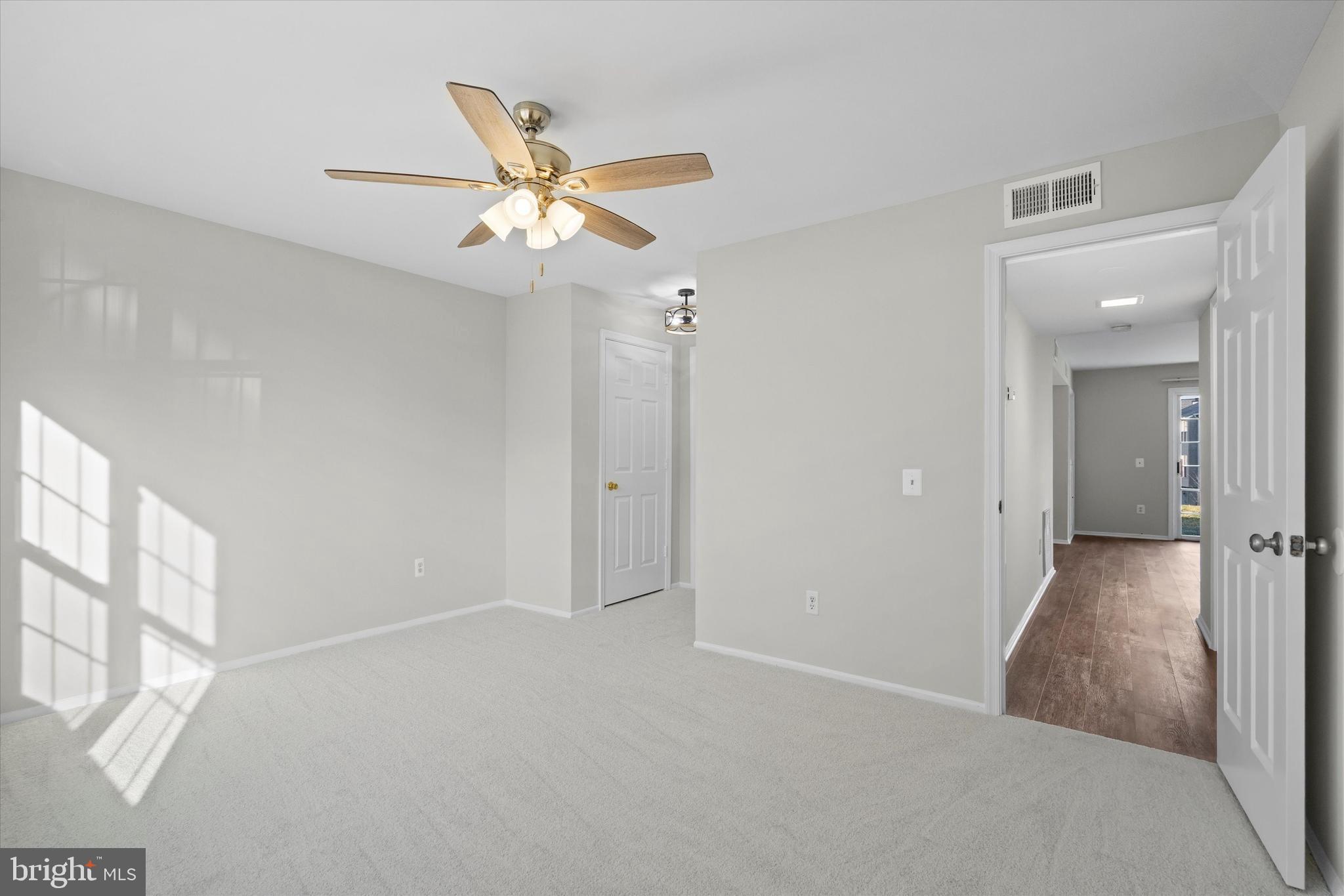129 Fort Evans Road Southeast, Unit A Leesburg, VA 20175 - Photo 18 of 33 a view of an empty room and a ceiling fan