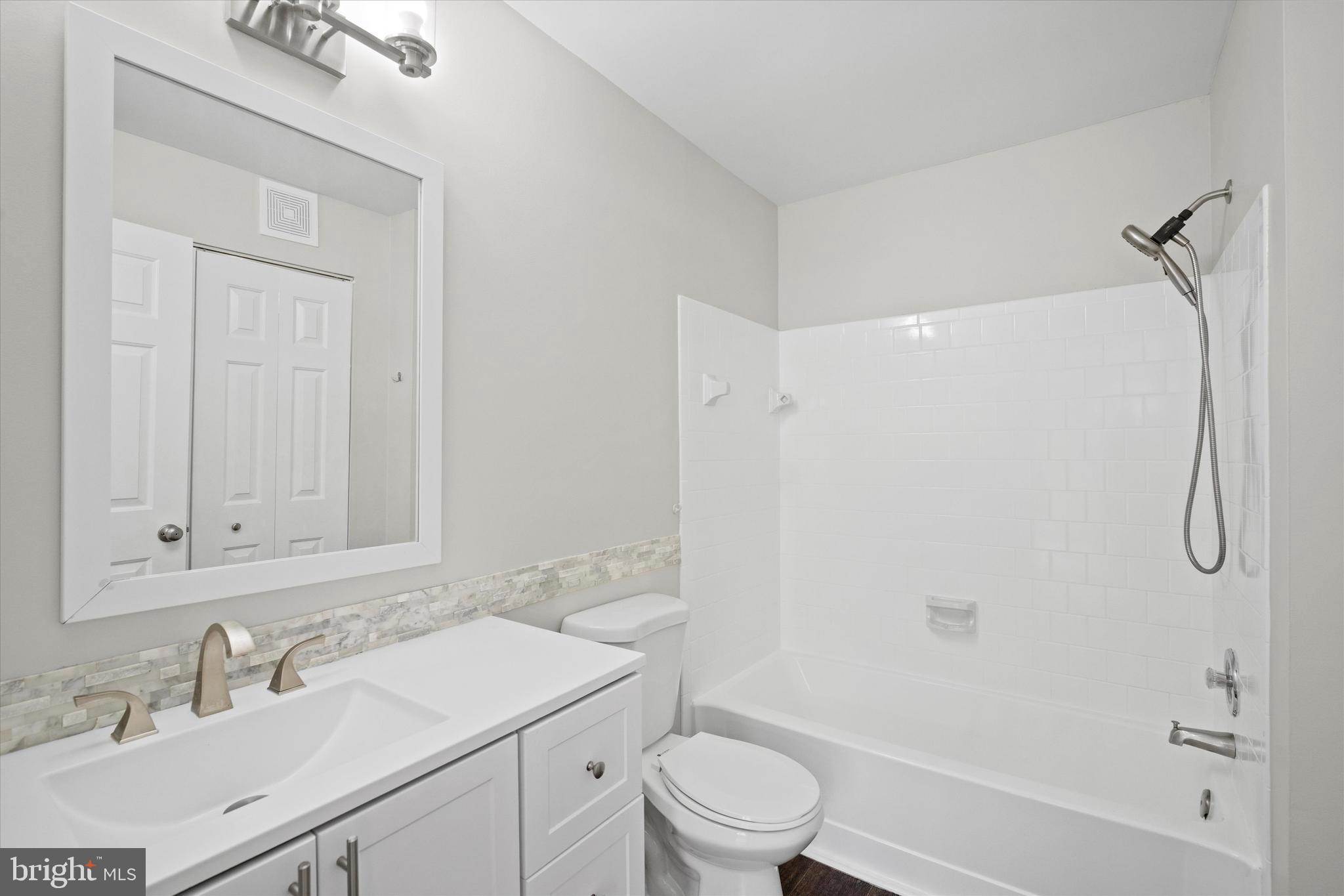 129 Fort Evans Road Southeast, Unit A Leesburg, VA 20175 - Photo 20 of 33 a bathroom with a sink a toilet and shower