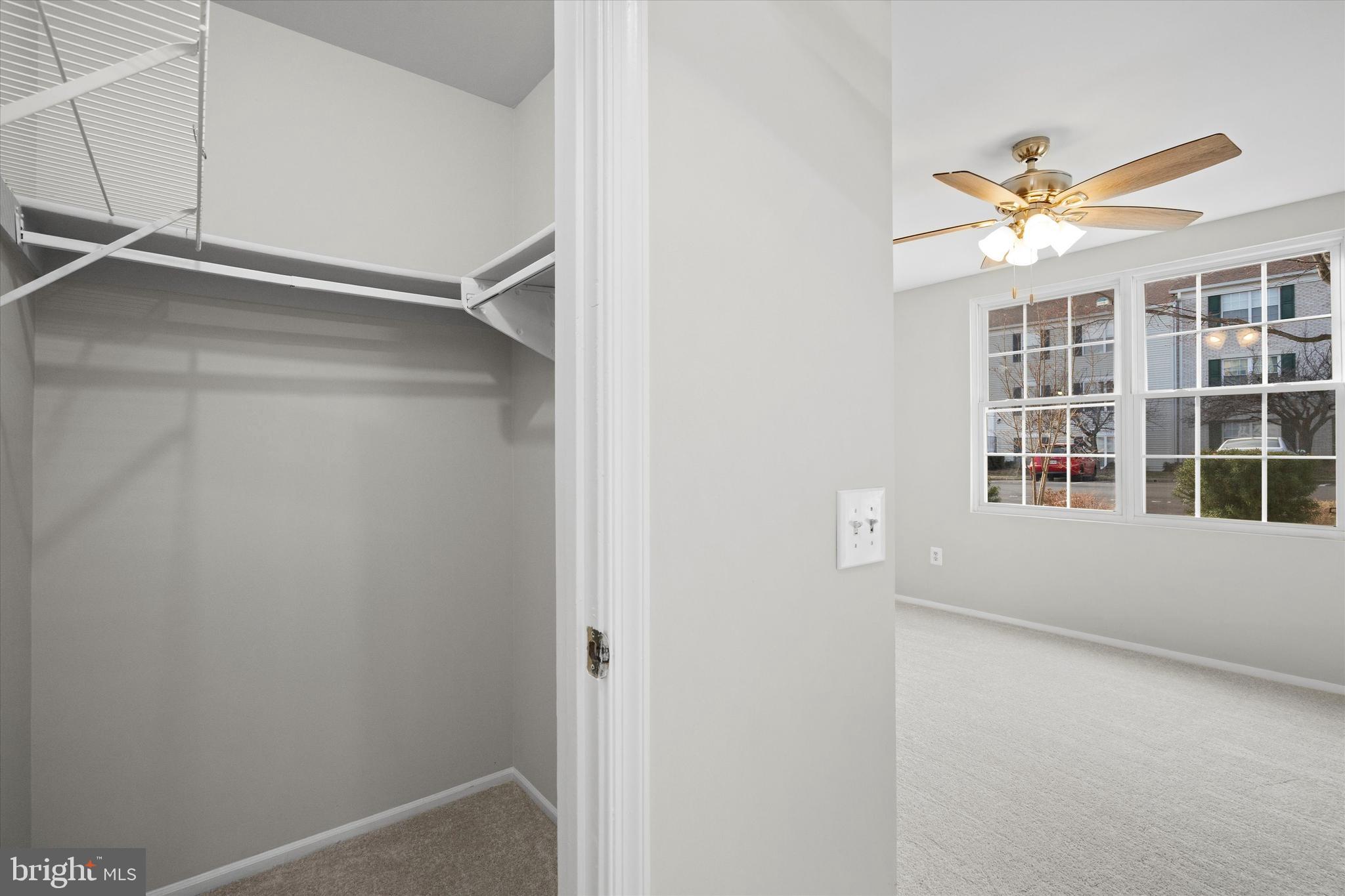 129 Fort Evans Road Southeast, Unit A Leesburg, VA 20175 - Photo 21 of 33 a view of an empty room with a window and a ceiling fan