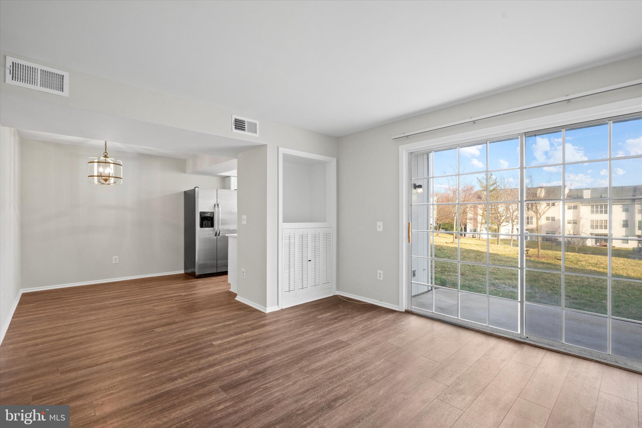 129 Fort Evans Road Southeast, Unit A Leesburg, VA 20175 - Photo 4 of 33 a view of wooden floor and windows in a room