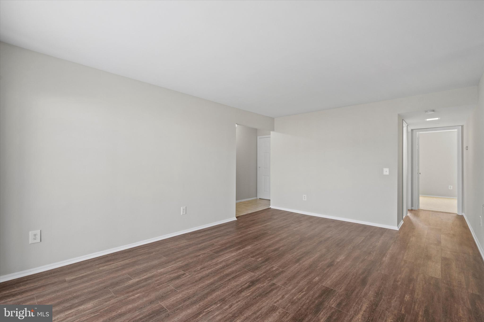 129 Fort Evans Road Southeast, Unit A Leesburg, VA 20175 - Photo 8 of 33 a view of an empty room with wooden floor and closet