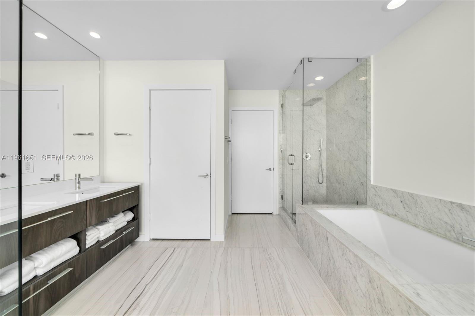 480 Northeast 31st Street, Unit 3401 Miami, FL 33137 - Photo 7 of 15 a bathroom with a double vanity sink and mirror with shower