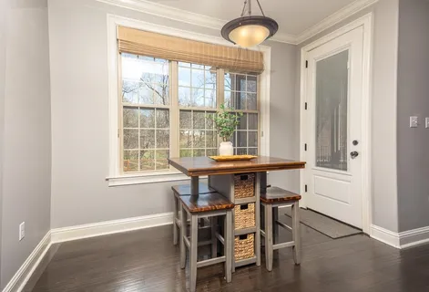 a dining room with furniture and window