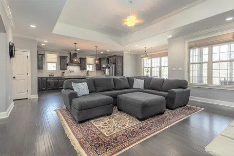 a living room with furniture and wooden floor