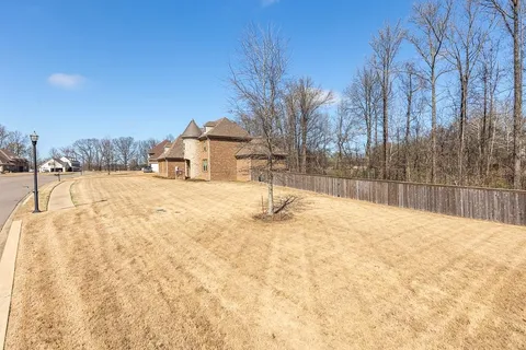 a front view of a house with a yard covered in snow