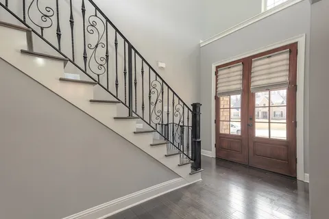 a view of an entryway with wooden floor