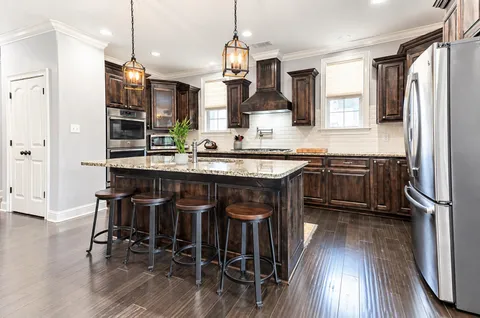 a dining room with furniture window and wooden floor